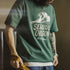 Person wearing a green t-shirt with 'Seaside Oregon' design